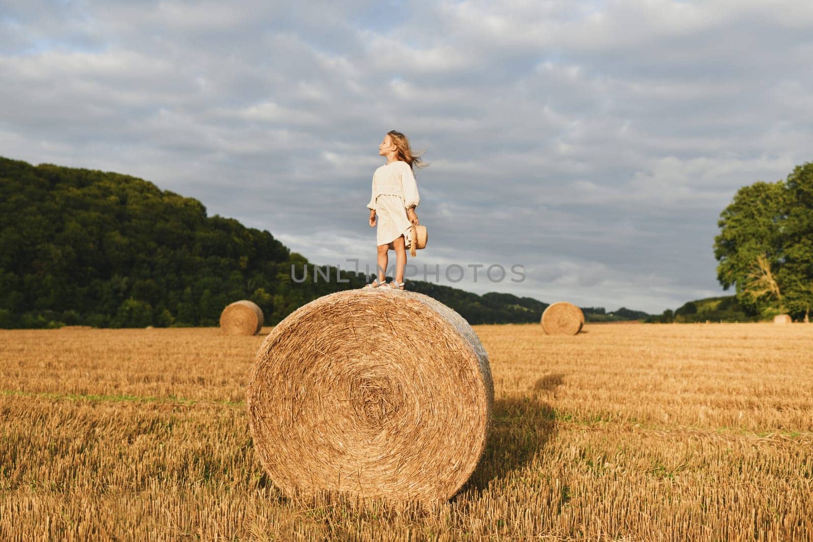 A girl on a bale of wheat Countryside