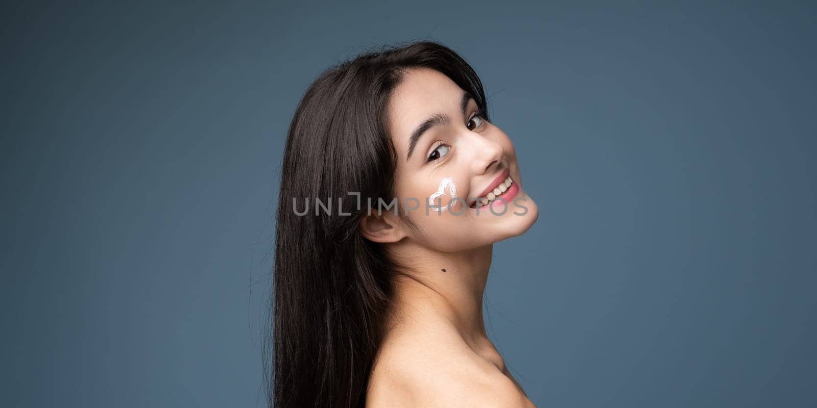 Skin cleaning. Young asian woman standing indoors. High quality photo