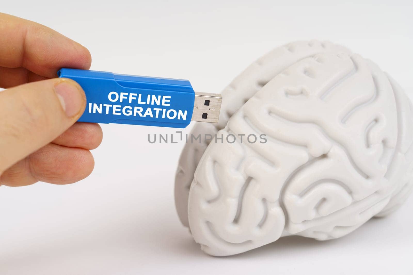 A man inserts a flash drive into his brain with the inscription - Offline Integration. Business and technology concept.
