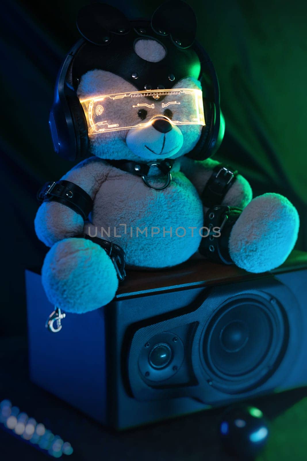 a toy bear dressed in leather BDSM belts, headphones and glowing glasses in neon light listens to music. dark background by Rotozey