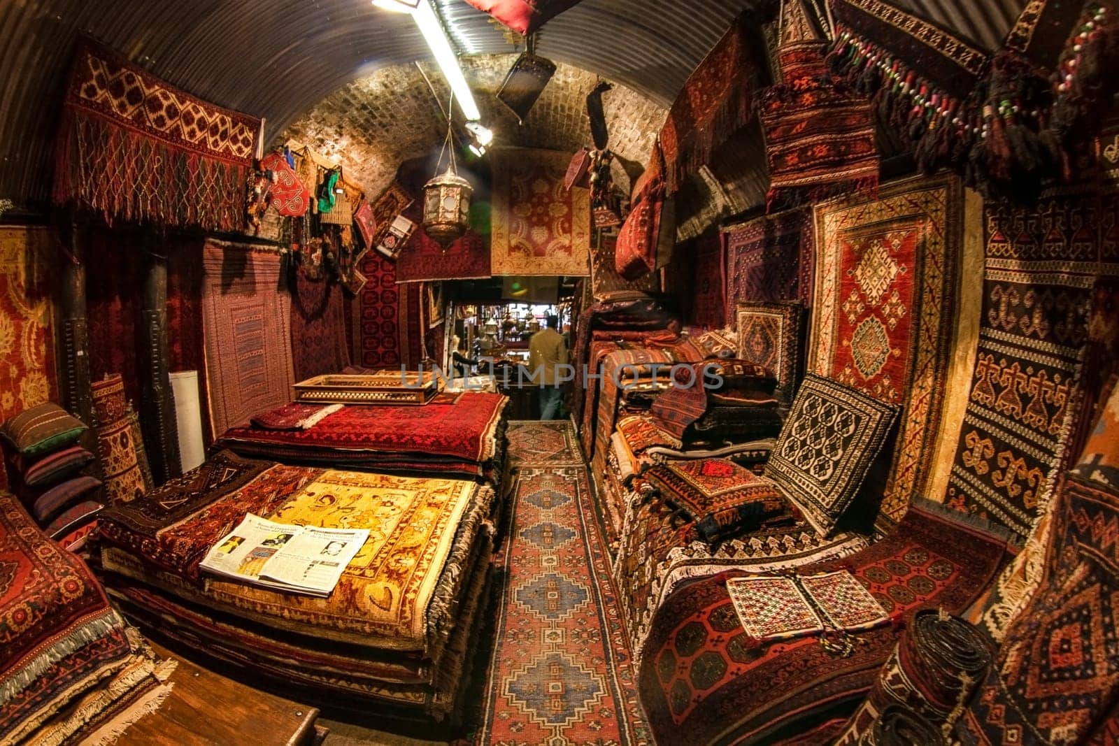 London, United Kingdom - April 01, 2007: Extreme wide angle (fisheye) photo  - oriental rugs and carpets on display at one of Camden Lock stalls, famous flea market in UK capital. by Ivanko