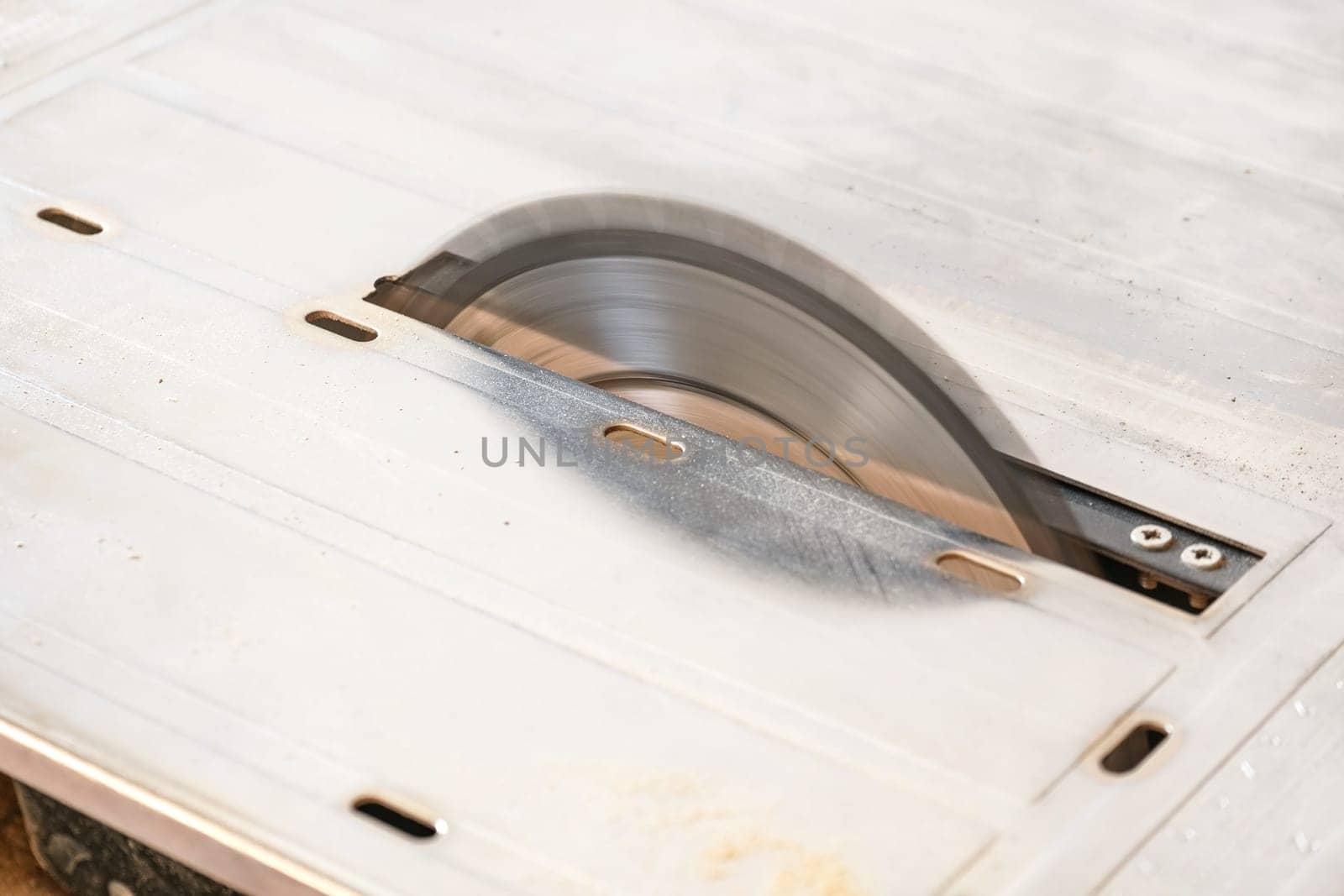 Detailed photo of rotating circular saw disc in motion, by Ivanko