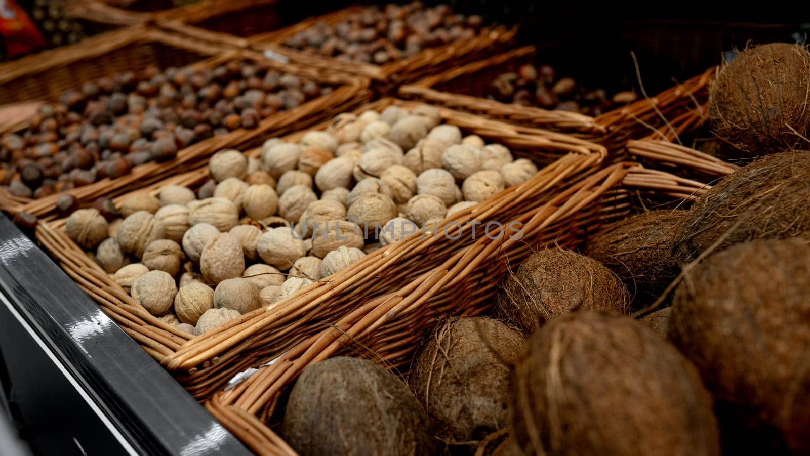 Supermarket Shelves Are Filled With Nuts And Coconuts, And Colorful Pumpkins Are Also Displayed
