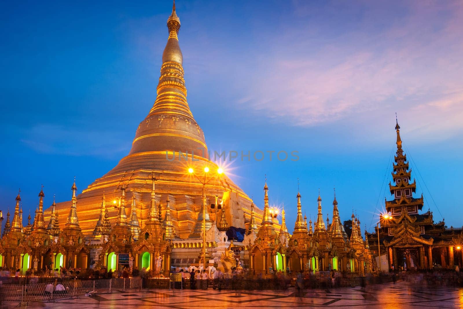 Myanmar famous sacred place and tourist attraction landmark - Shwedagon Paya pagoda illuminated in the evening. Yangon, Myanmar Burma
