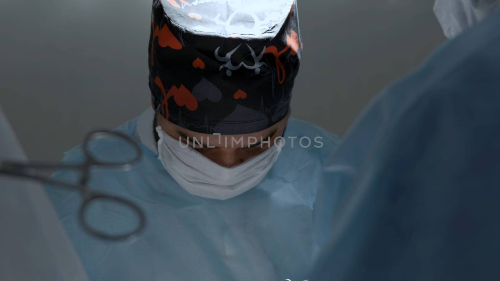 Portrait of surgeon wearing medical mask standing in operation theater at a hospital. Action. Healthcare, emergency medical service concept