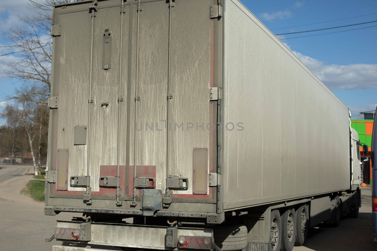 Truck. Large body. Transportation of goods. Dirty truck body. White bodywork.