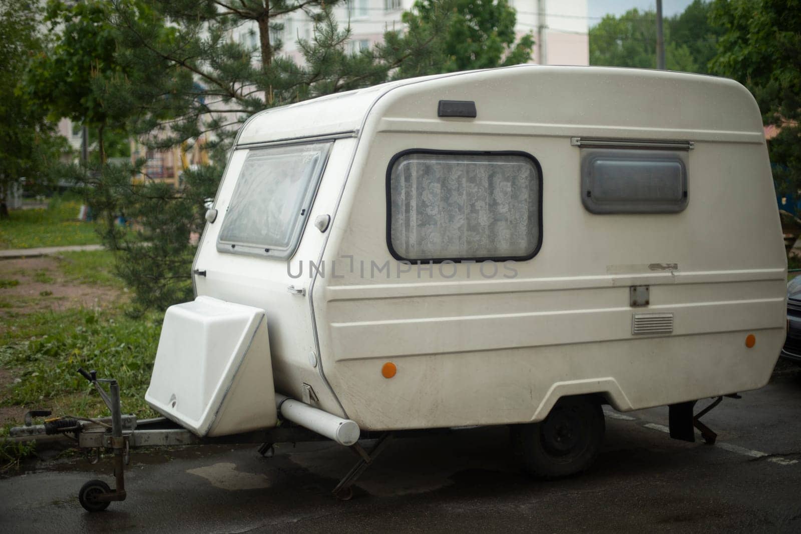 House Trailer. Caravan. White car trailer. Parking place.