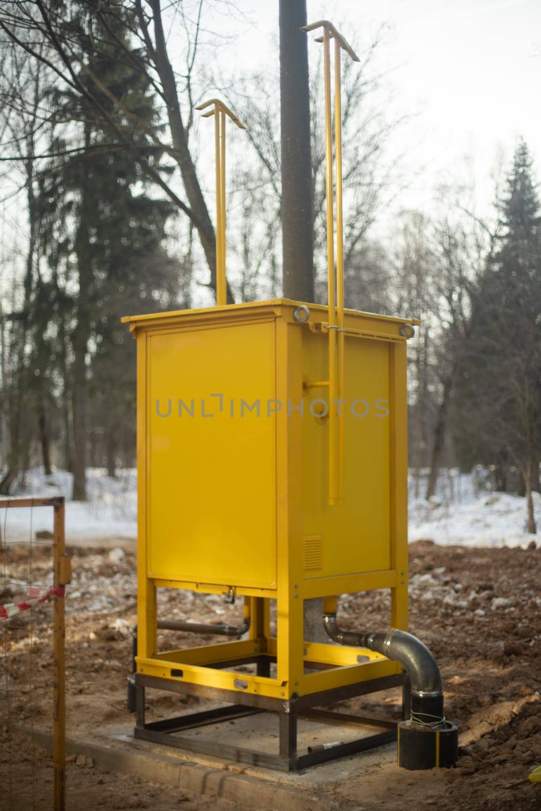 Gas equipment on street. Yellow technical structure. Urban infrastructure. by OlegKopyov