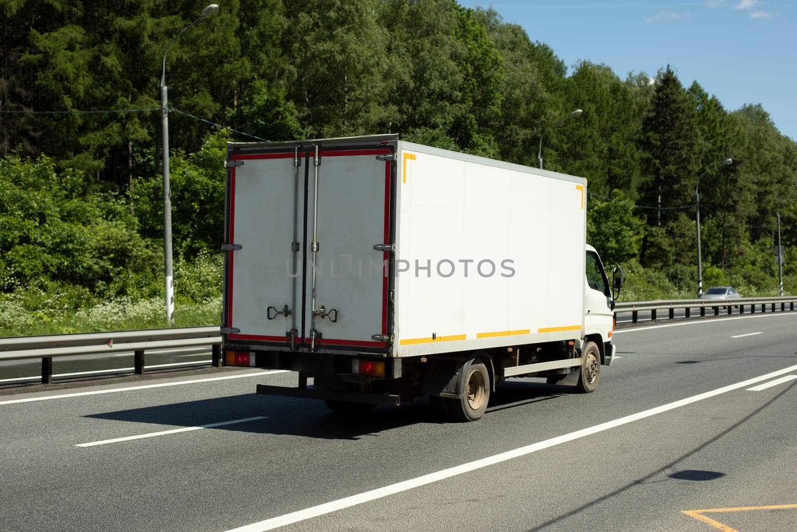 Freight transport on road. Car is driving on highway. Freightage. They were highway. Road outside city.