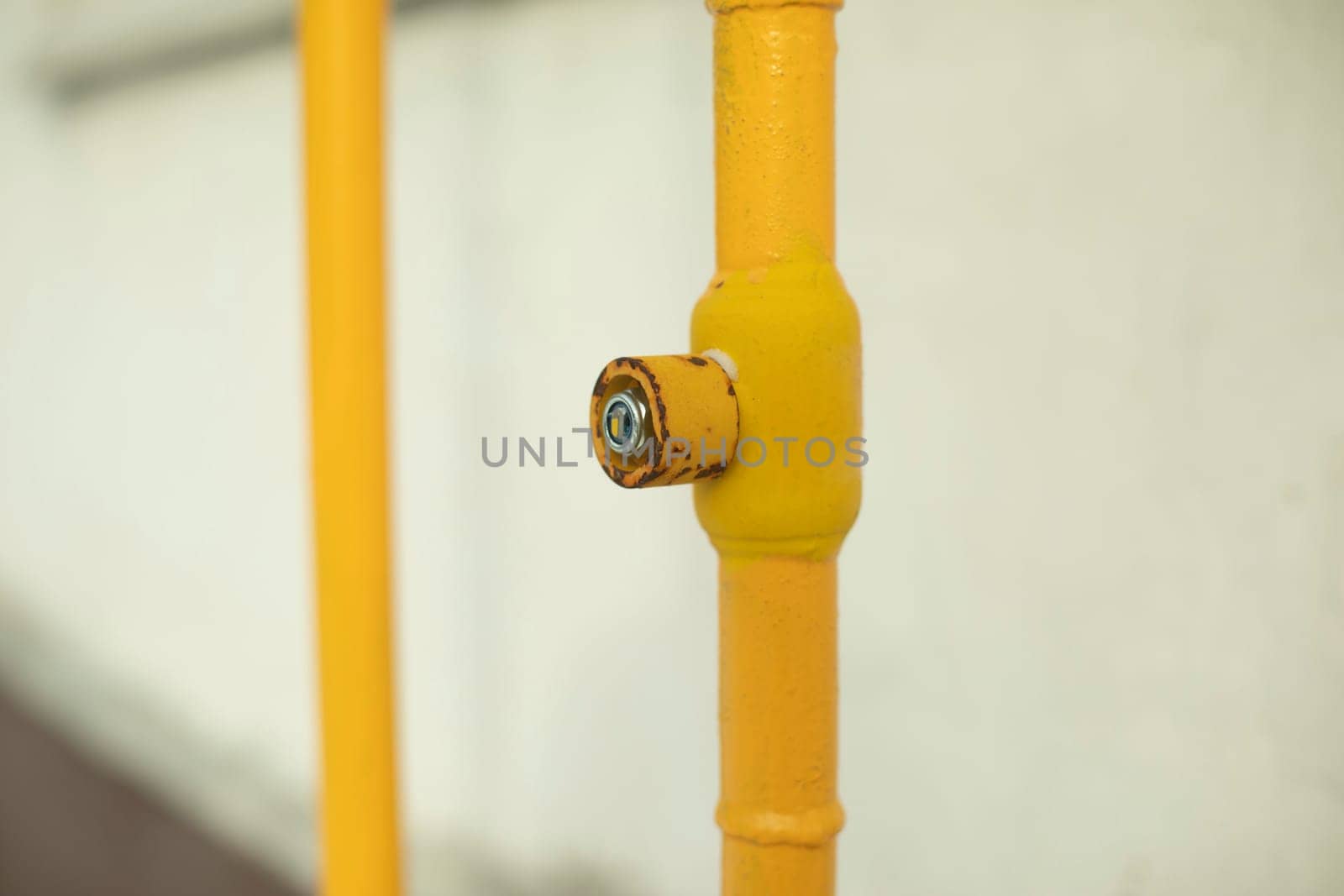 Gas pipe on house. Yellow pipe. Gas supply to building. Infrastructure details.