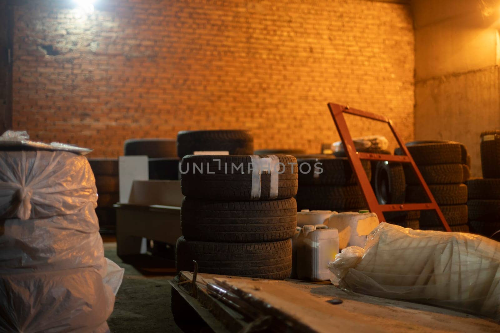 Things in stock. Car wheels in the garage. Brick storage room. by OlegKopyov