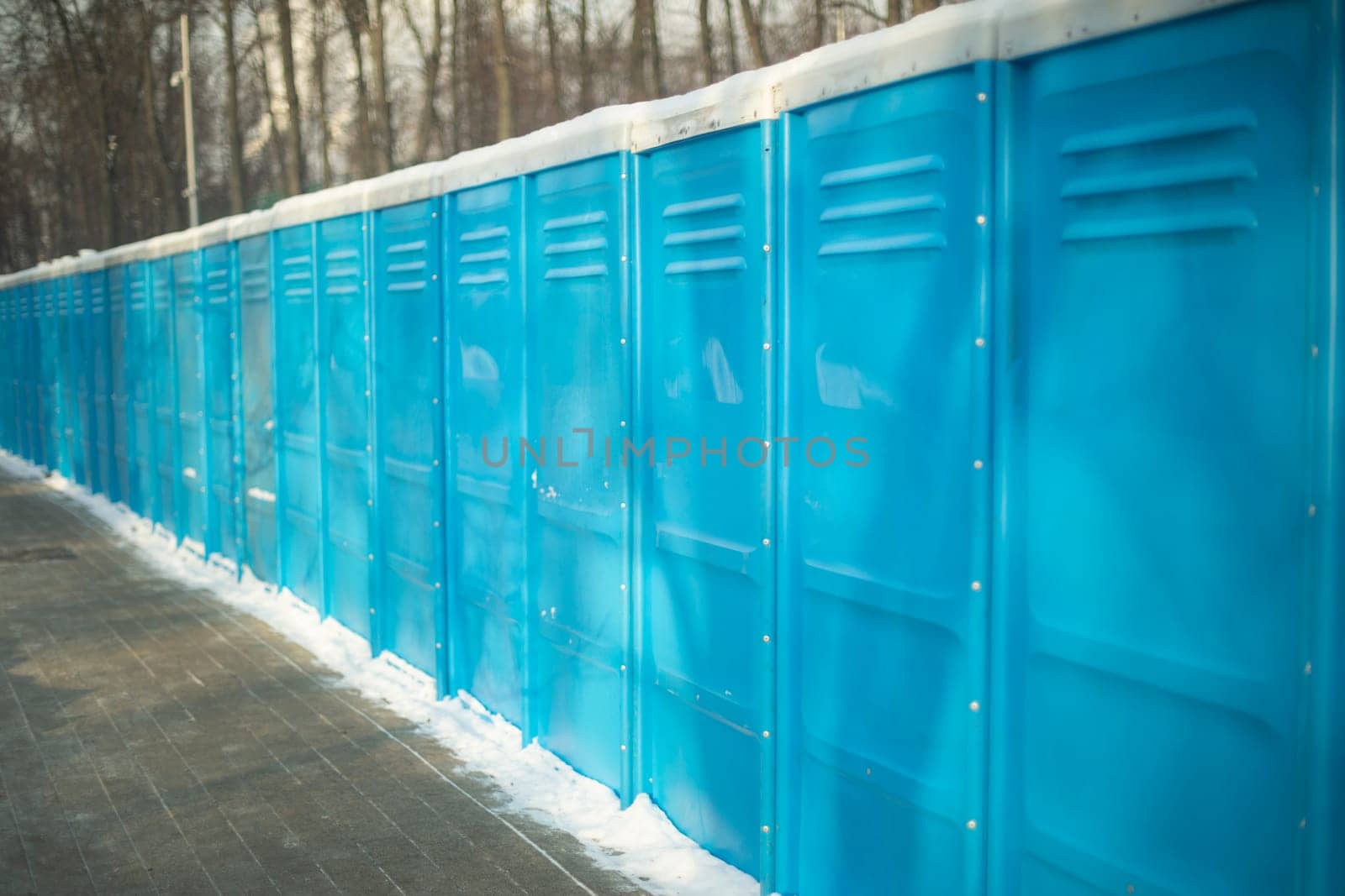 Toilet outside. Toilets stand in row. Blue booths. by OlegKopyov