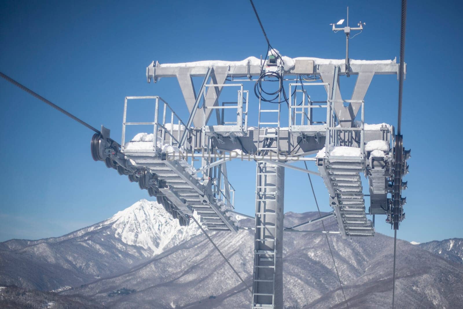 Lift to the mountain. A vehicle for a quick climb to the top. Cableway in the mountains. Cabins for transportation. Booths on steel cables stretched between racks. Relay road technology.