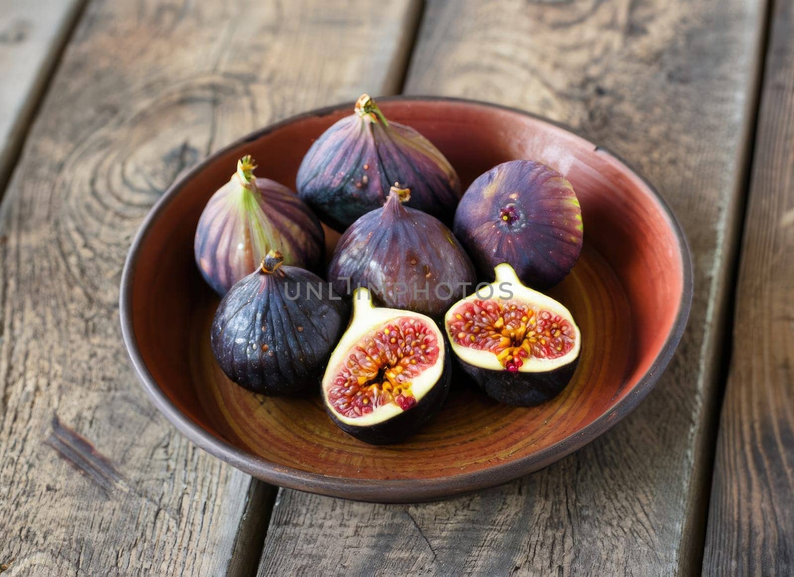 Fresh ripe figs and fig sliced in half on plate. AI Generated. by PeaceYAY