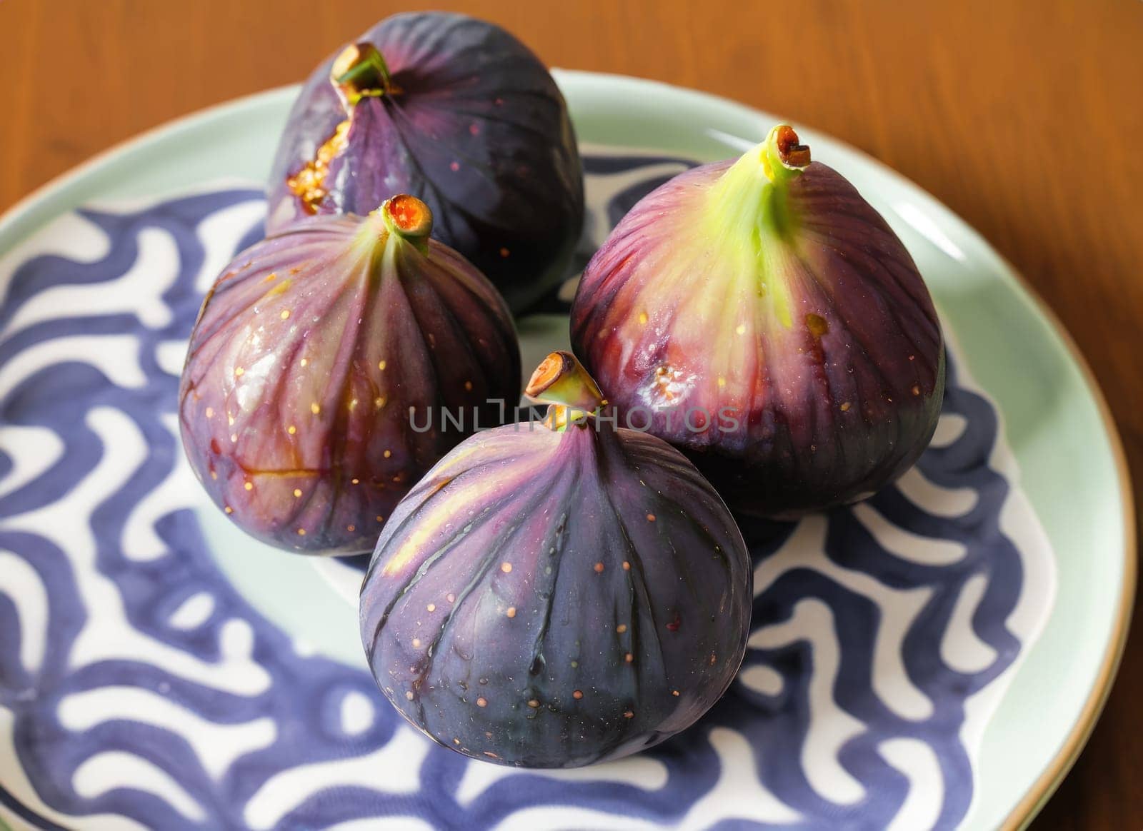 Fresh ripe figs and fig sliced in half on plate. AI Generated. by PeaceYAY
