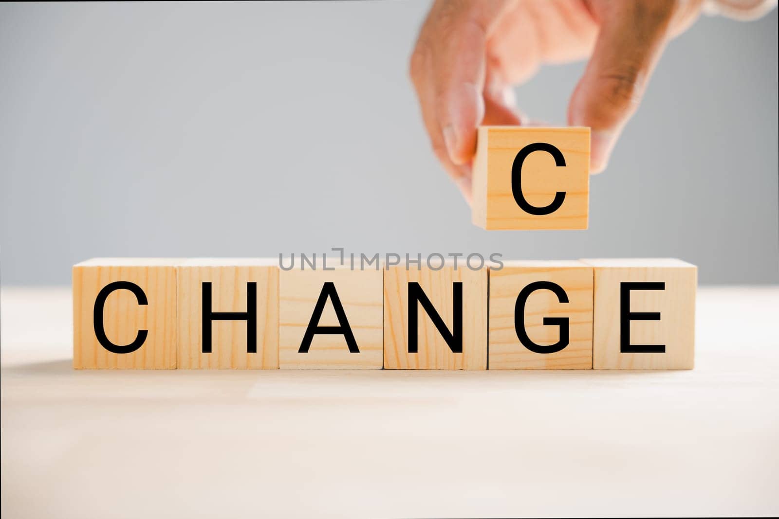 Businessman hand flips wood block, changing CHANGE to CHANCE. Success, strategy, and positive mindset emphasized. Vintage table adds character. Change is evident.
