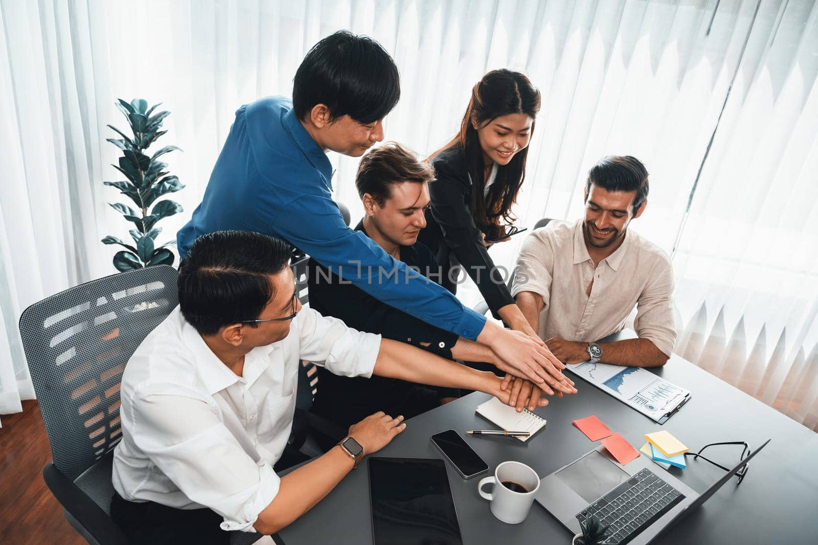 Group of diverse office worker join hand together in office. Prudent by biancoblue
