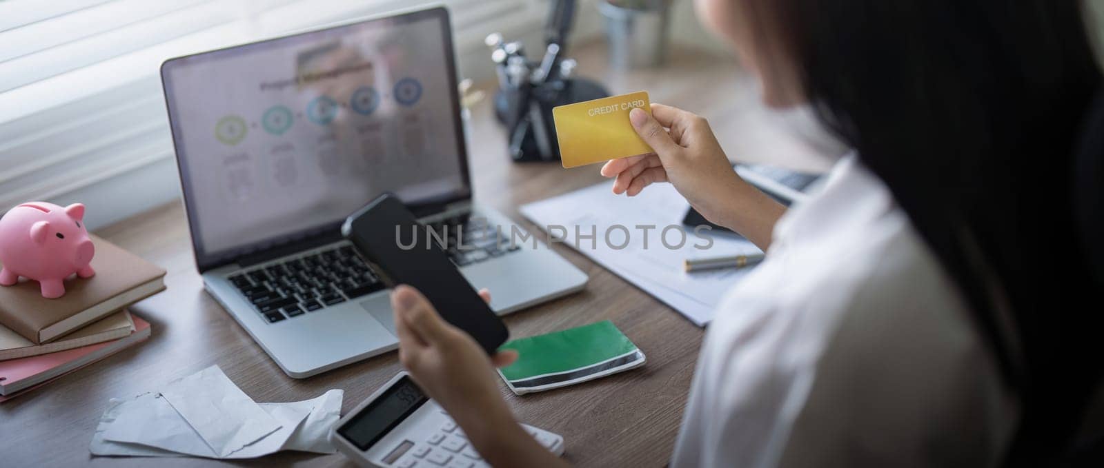 Woman on desk with smartphone, credit card and ecommerce payment for online shopping at home. digital bank app and sale on store website with internet banking.