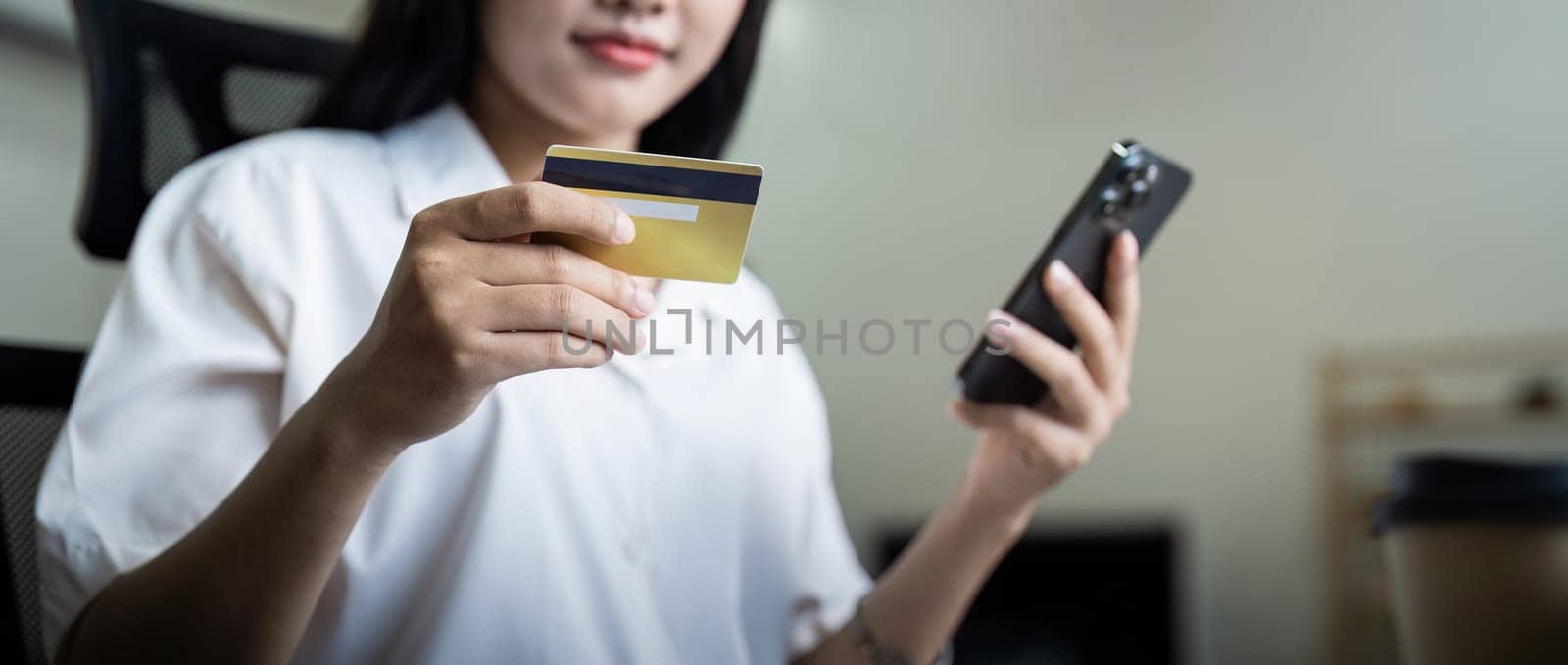 Woman on desk with smartphone, credit card and ecommerce payment for online shopping at home. digital bank app and sale on store website with internet banking.