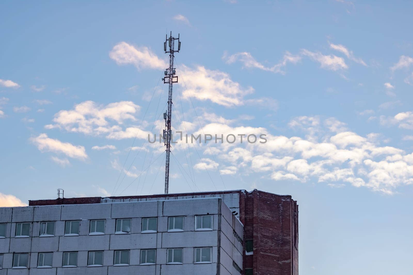 Communication antenna on the roof of a multistory building by Vera1703