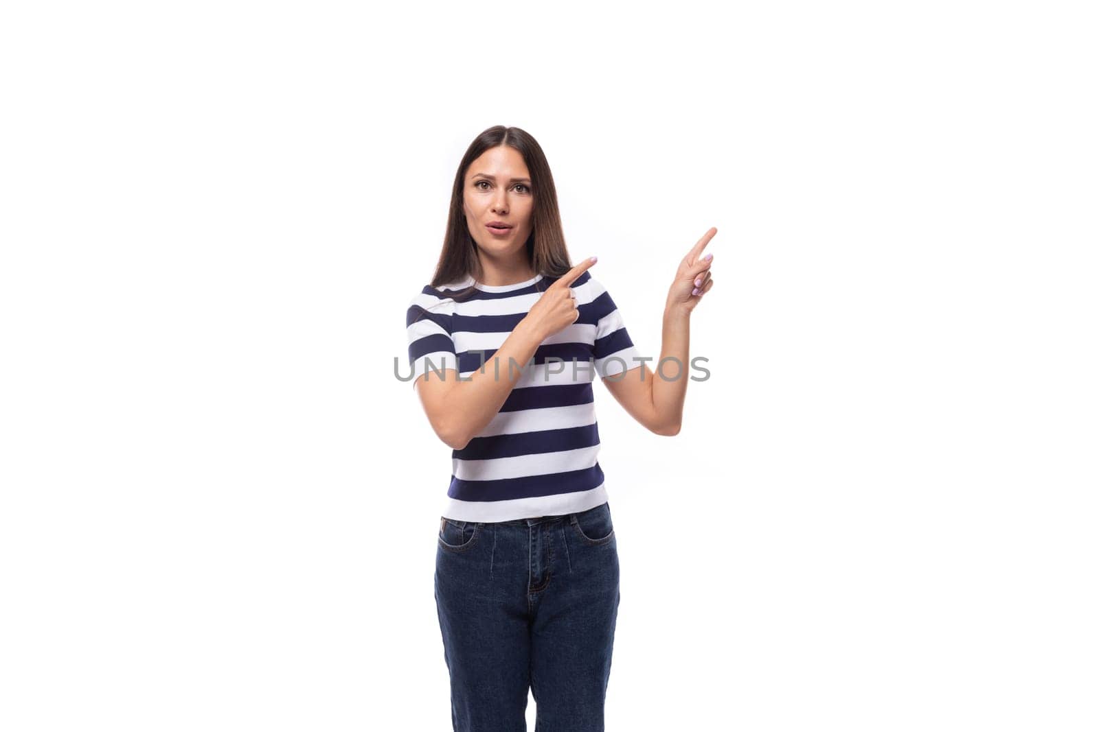 a young kind brunette European lady of a slender physique is dressed in a striped summer T-shirt.