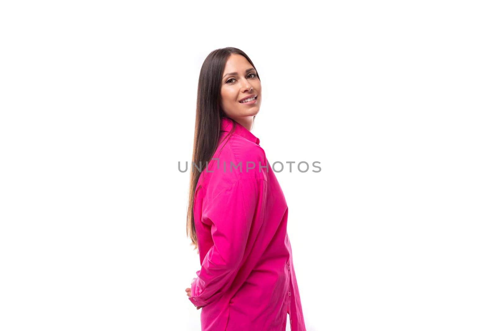stylish caucasian woman with black straight hair is dressed in a crimson shirt on a white background.