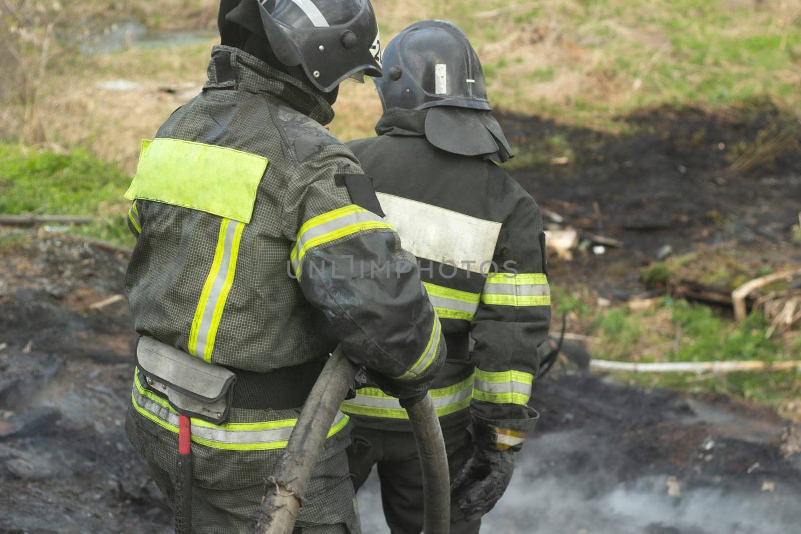 Lifeguard on duty. Firefighter puts out fire. Details of fire. Rescuer in Russia. by OlegKopyov