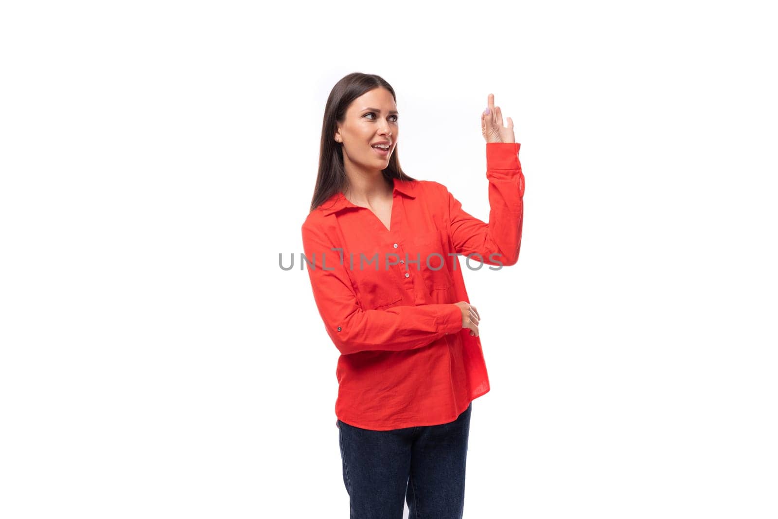 young pretty brunette caucasian model woman dressed in fashionable red shirt tells interesting news on white background.