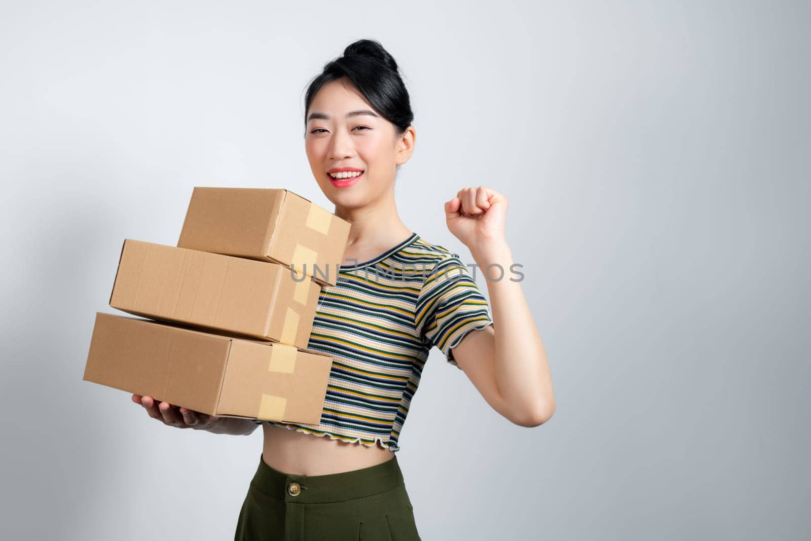 Portrait of beautiful happy woman carry boxes with orders.