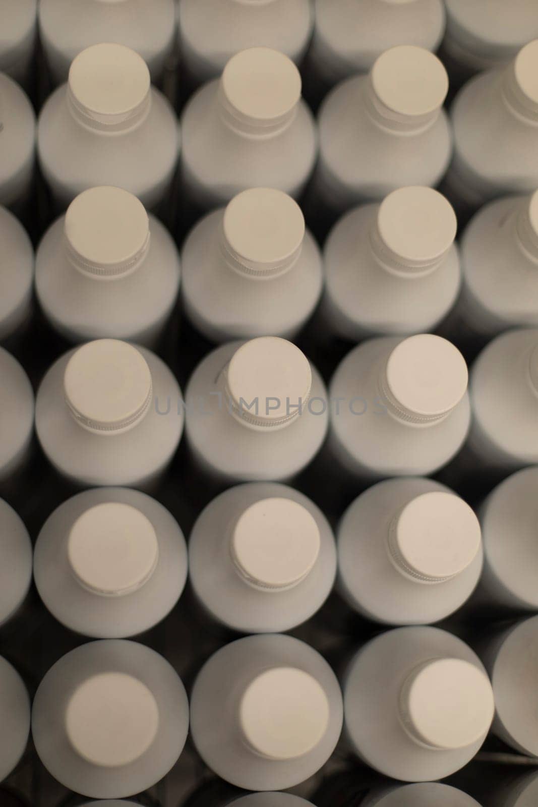 White plastic bottles top view. Lots of milk bottles. Texture from beverage containers.