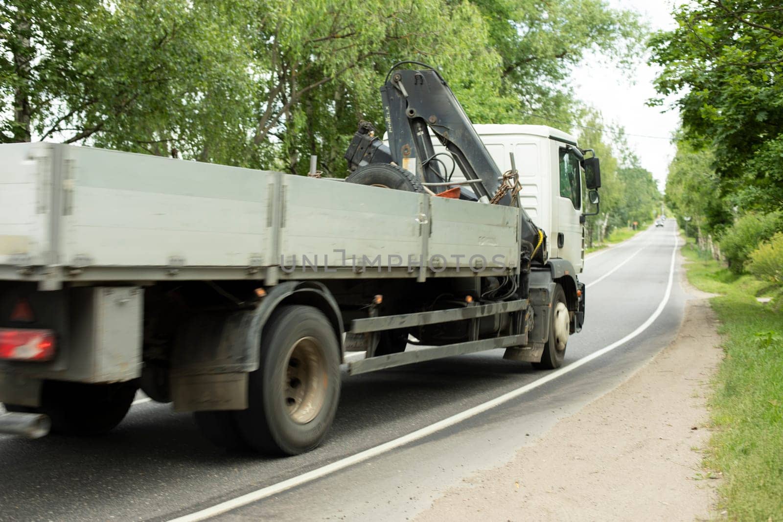 Truck on road. Transportation of goods. Big car on narrow highway. Details of trip.