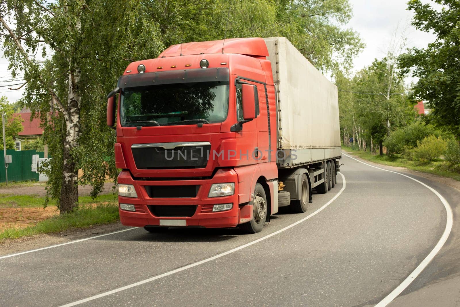 Truck on road. Transportation of goods. Big car on narrow highway. by OlegKopyov