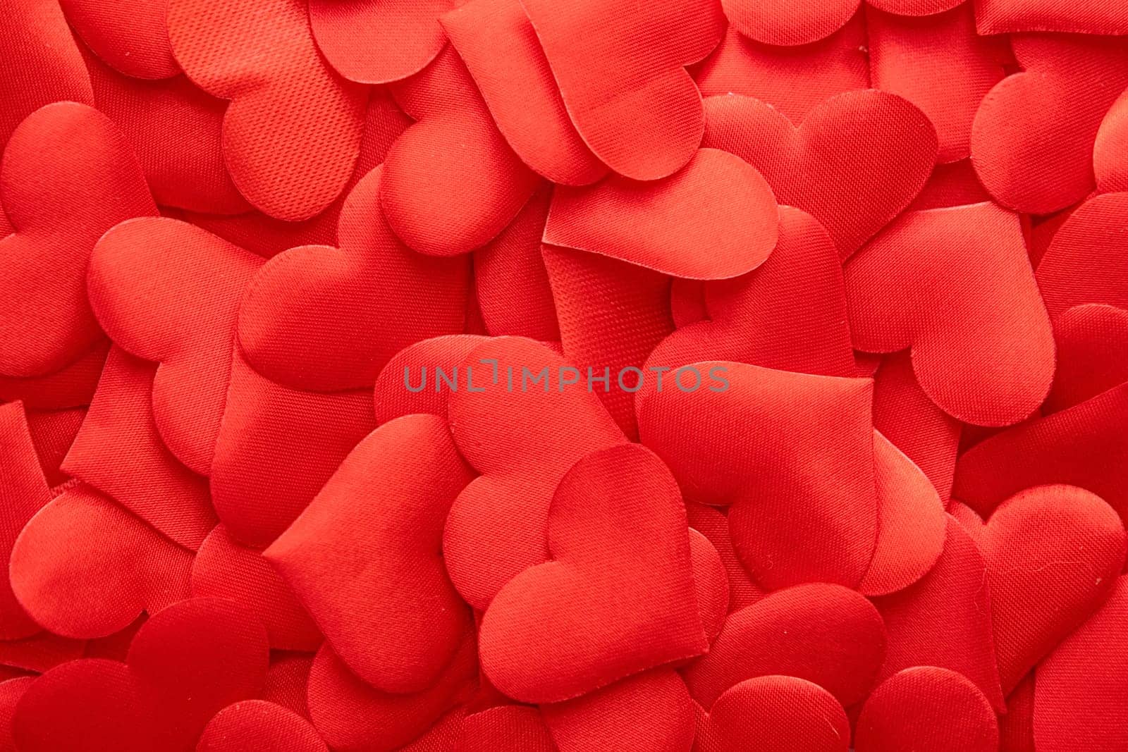 Valentines day. red confetti in shape of hearts . texture