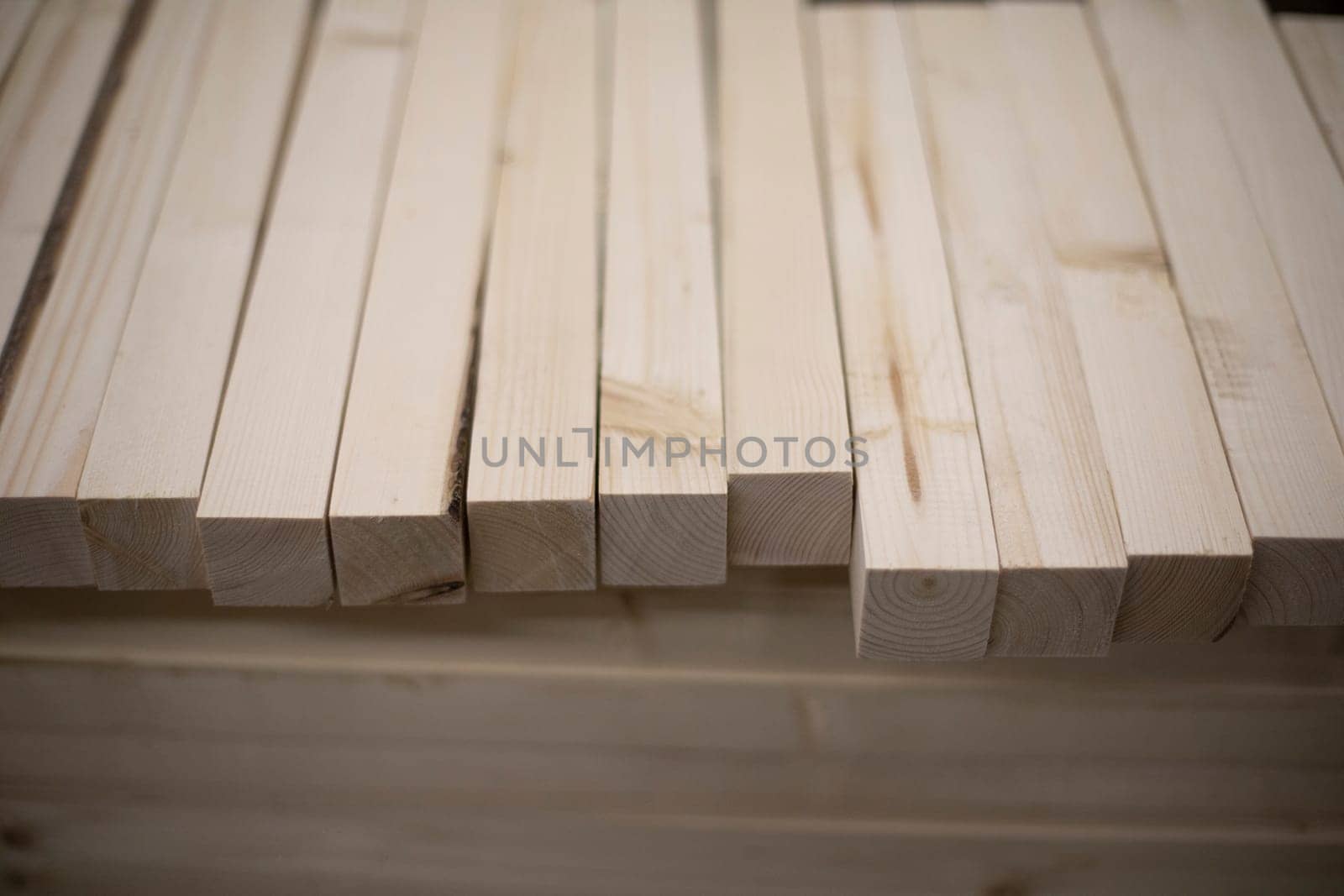 Boards in stock. Wooden blanks. Bars made of wood of light color. Details of steelwork.