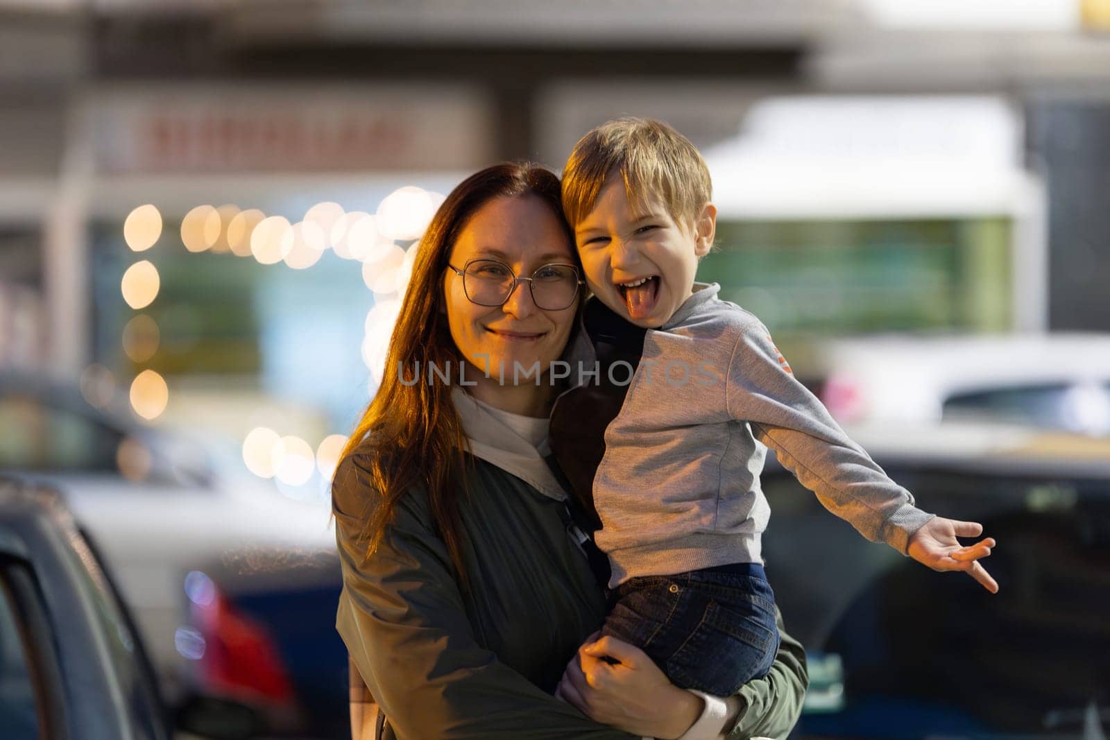 A Loving Mother with little son on night street - portrait