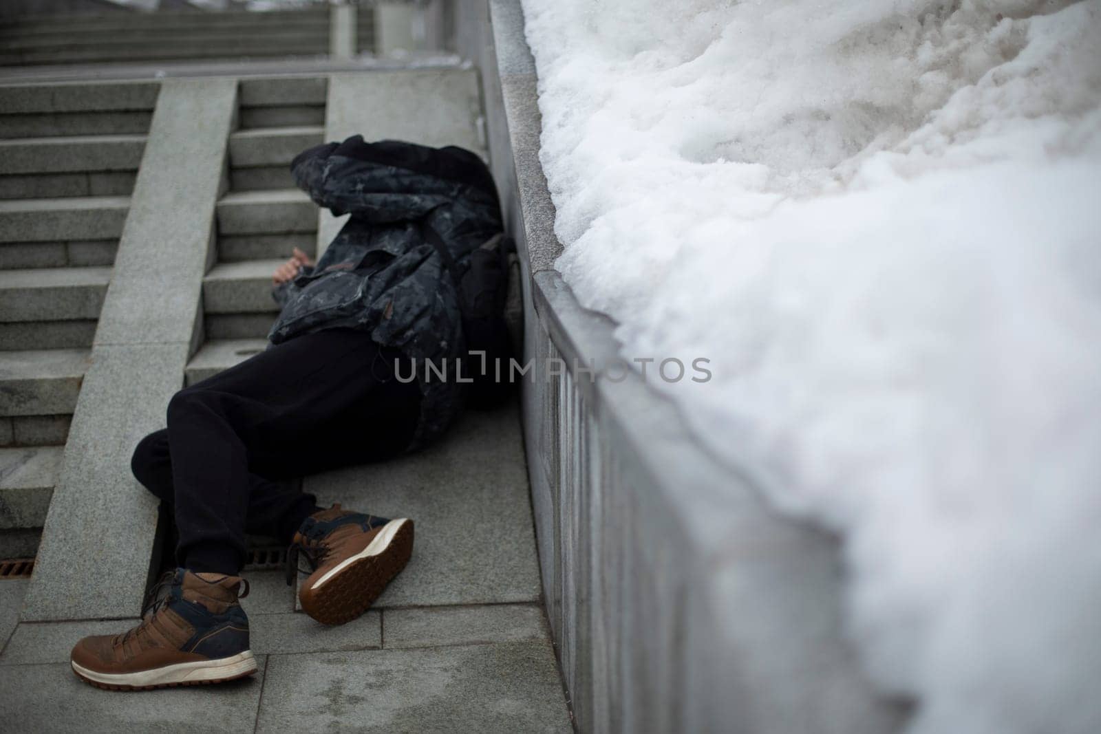 Man fell. Guy is lying on pavement. Falling on stairs. Man stumbled. Loss of balance.