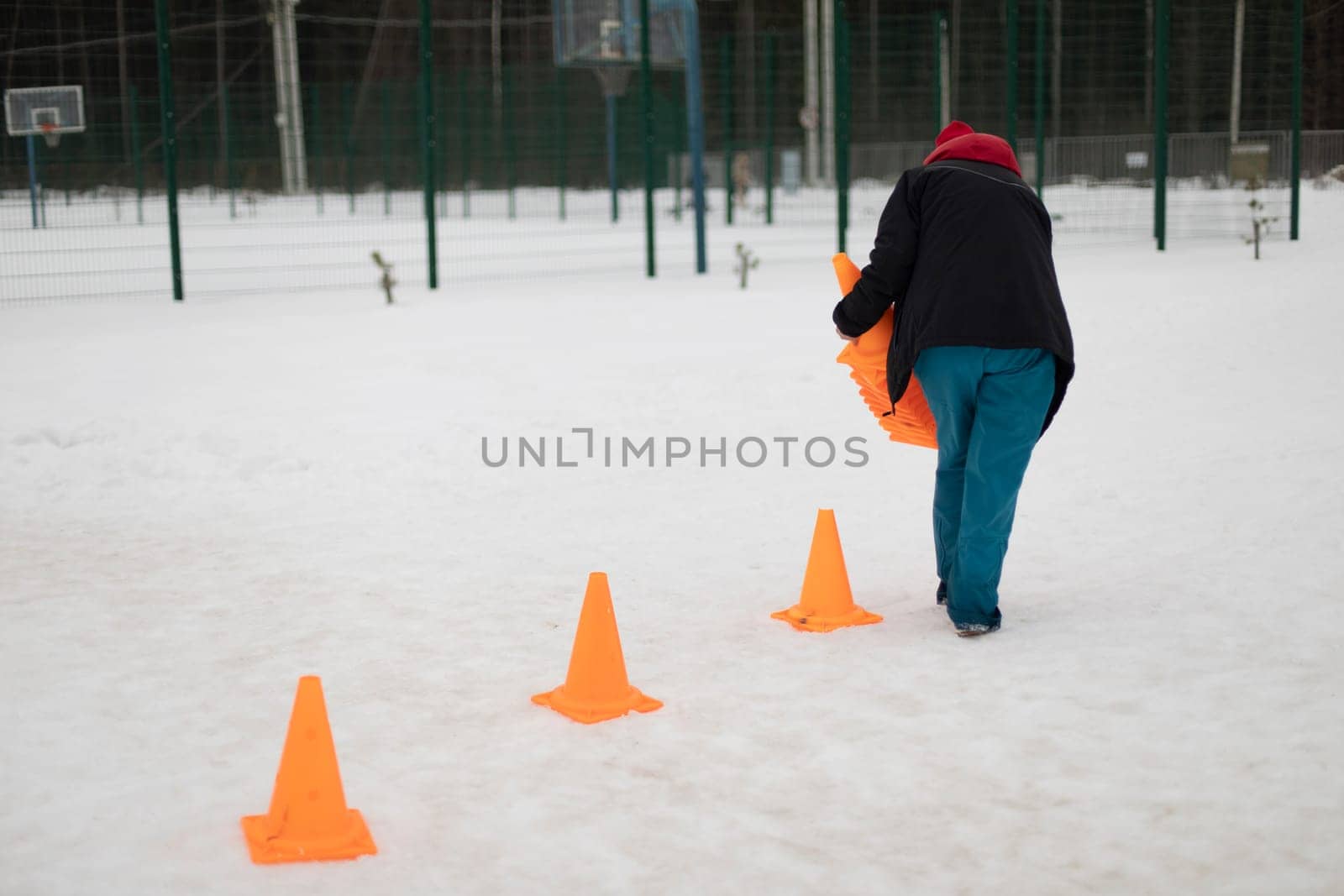 Installation of signal tubes. Orange caps on road. Sports equipment for precision movement. Marking of territory. by OlegKopyov