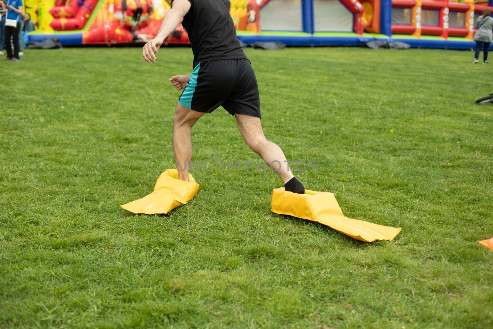 Child plays on green grass. Active lifestyle in summer. Children in park. by OlegKopyov