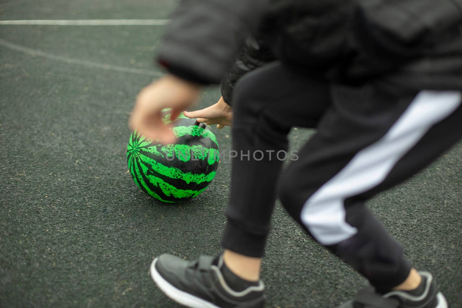 Relay for children. Sports game. Children roll meat around playground. Fun in summer. Competition for agility.