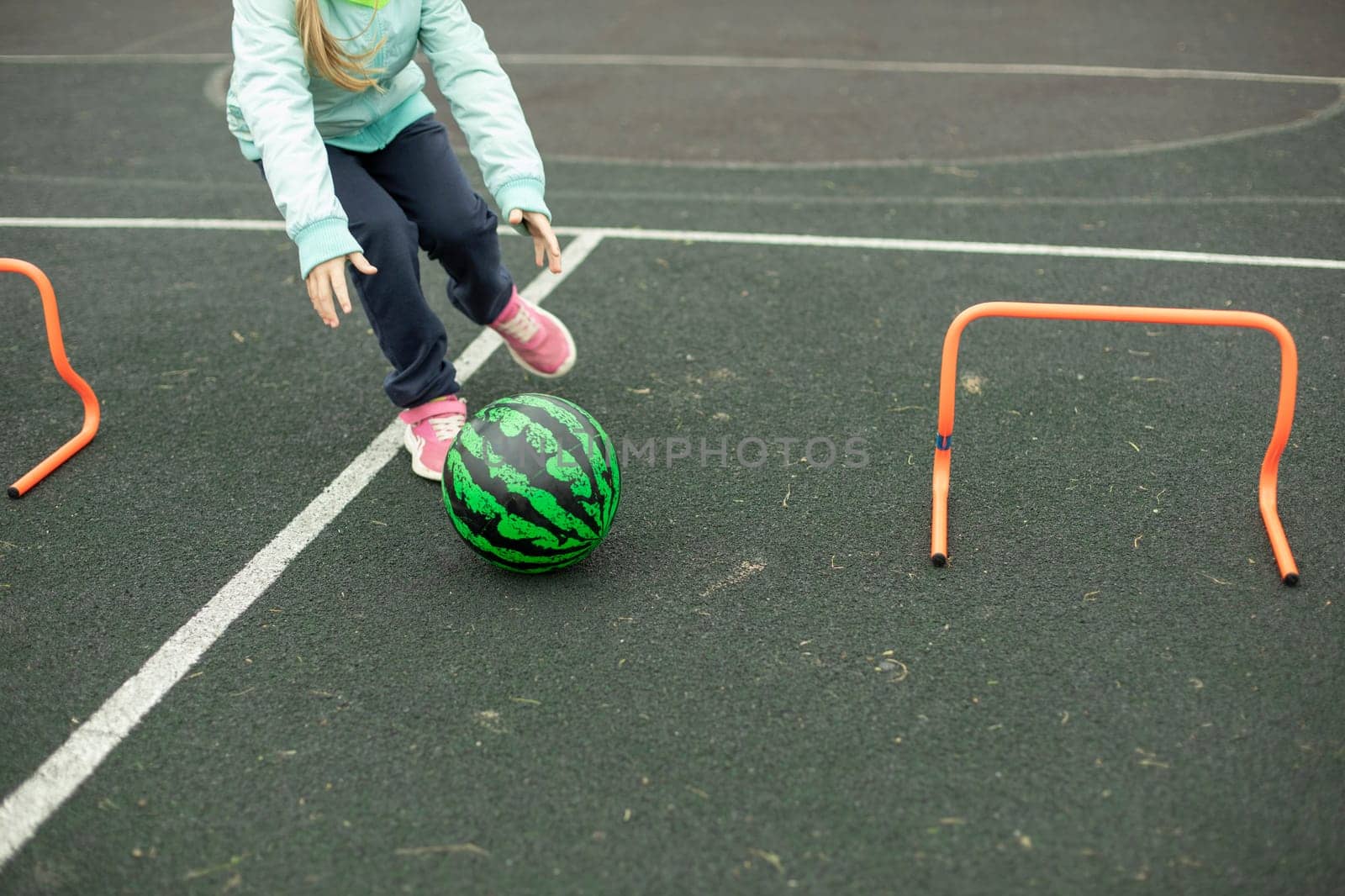 Relay for children. Sports game. Children roll meat around playground. Fun in summer. by OlegKopyov