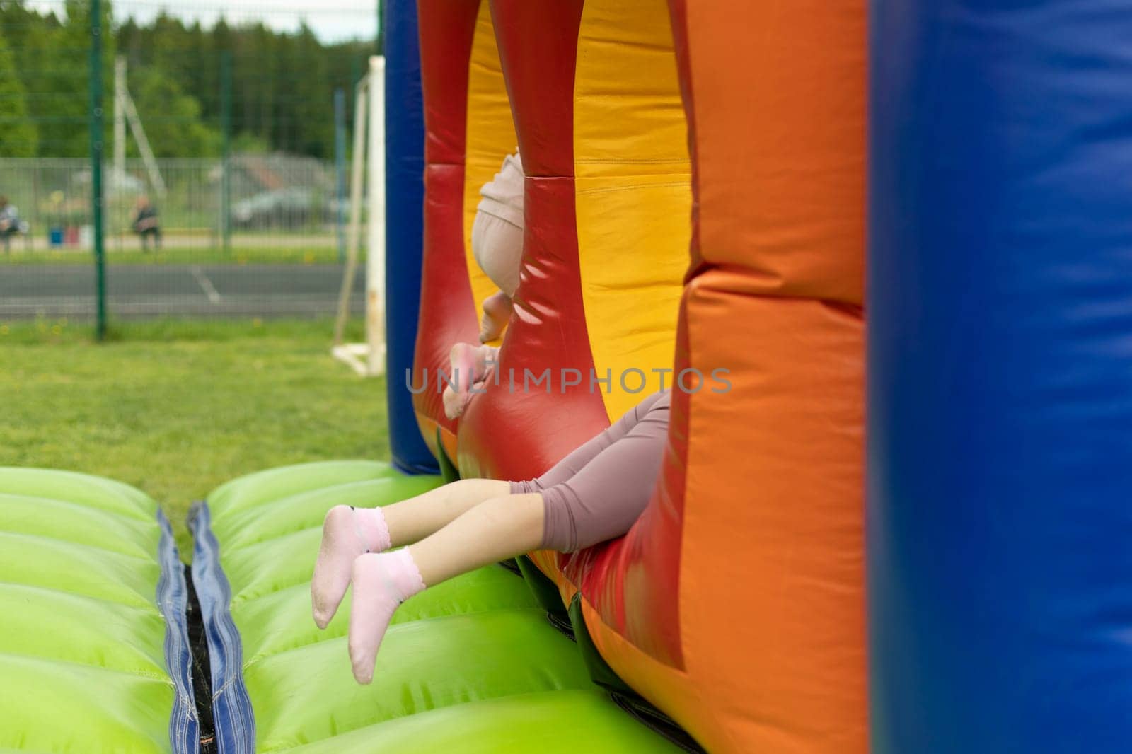 Child on obstacle course. Children's entertainment area. Inflatable design for children.