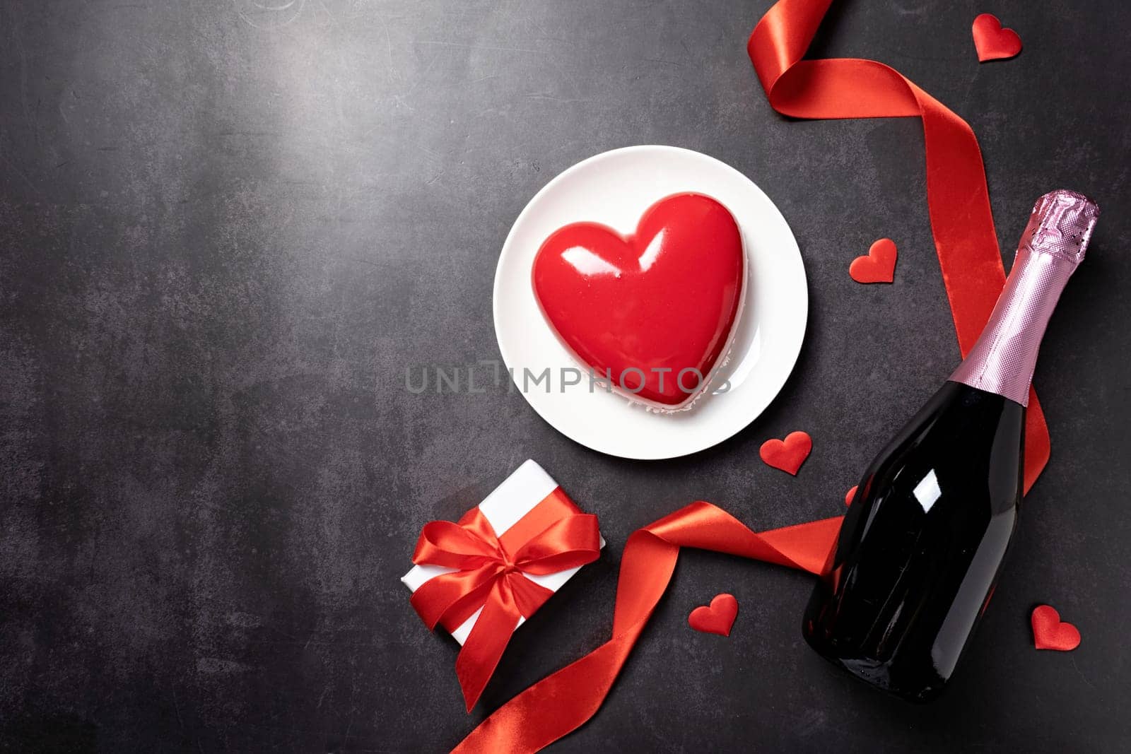 heart shaped glazed valentine cake and flowers on black background by Desperada