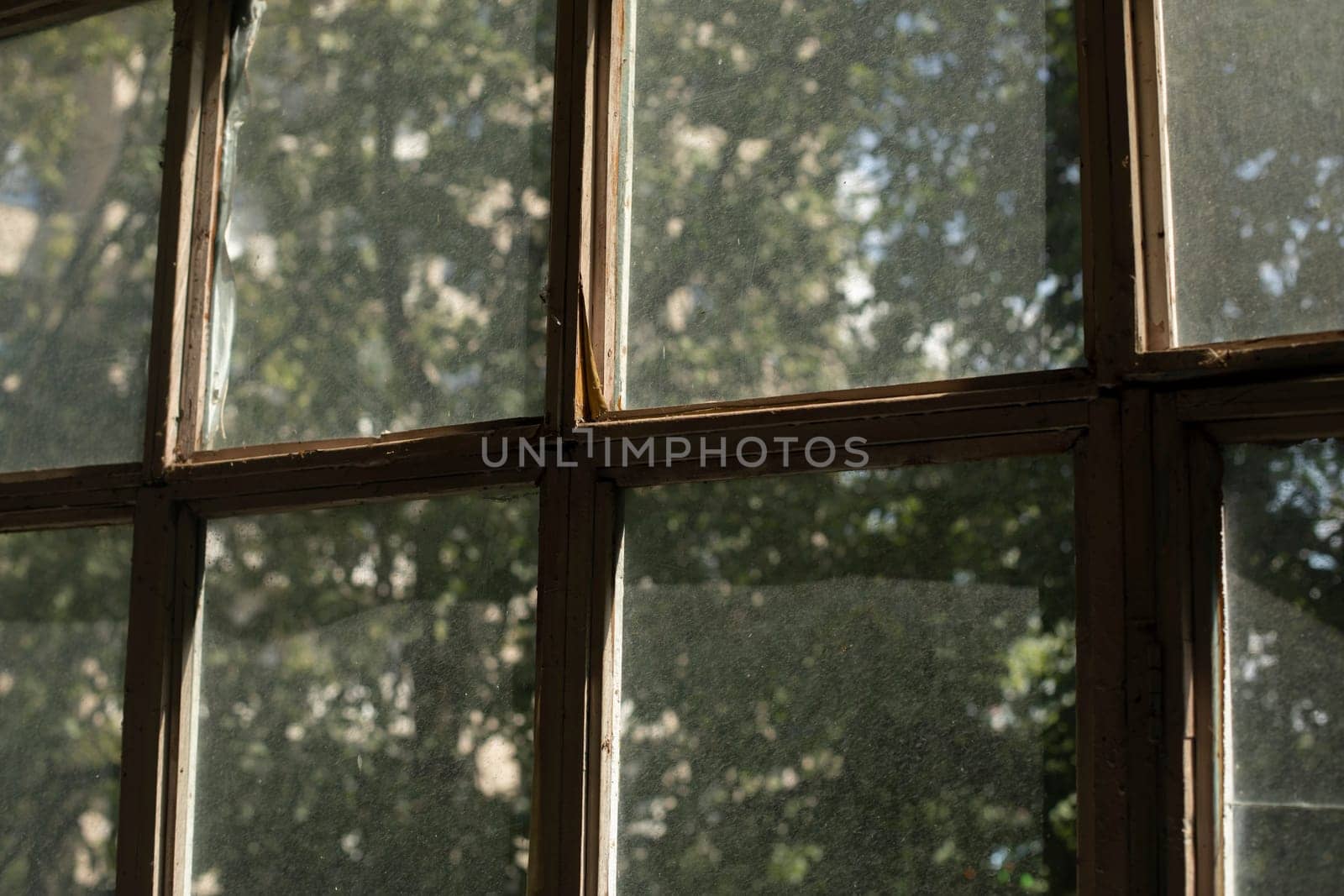 Old window frame. Glass on window. Interior details. Morning light on dusty glass. Old housing.