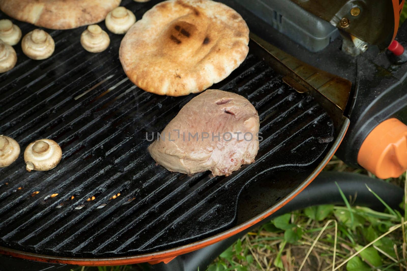 Frying meat on street Cooking food on vacation, Street kitchen. Picnic details. Delicious lunch.