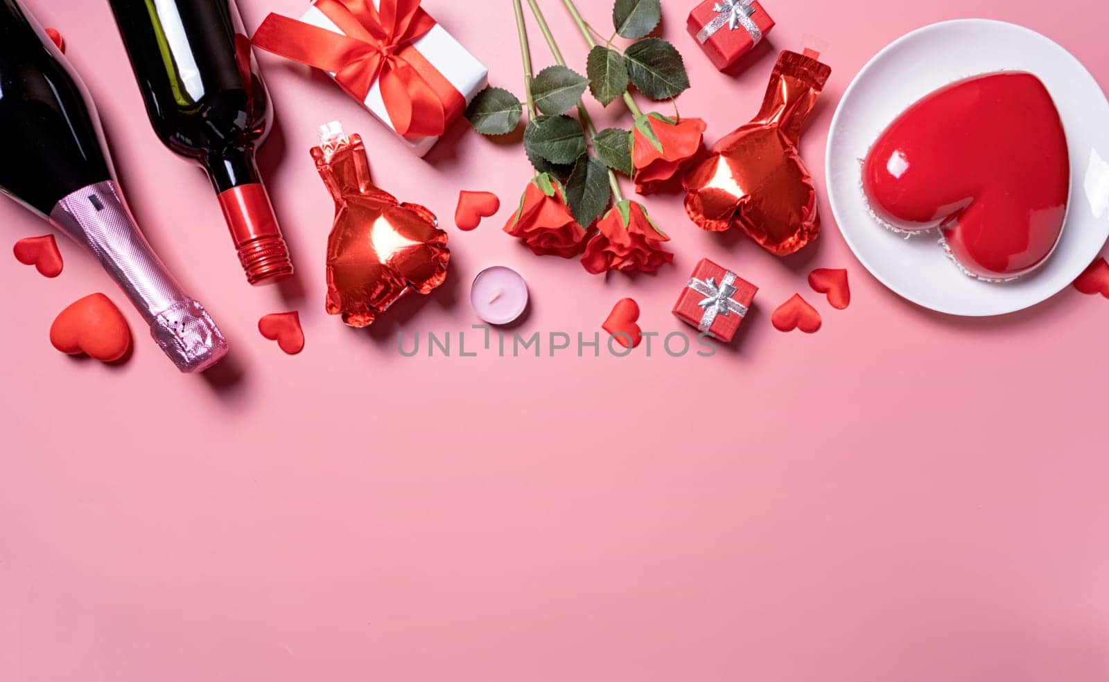 Valentines day. heart shaped glazed valentine cake and flowers on pink background, copy space