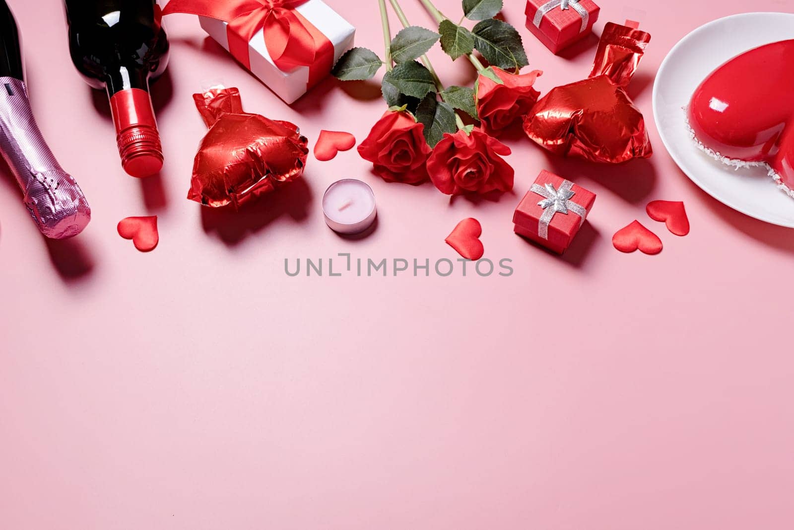 Valentines day. heart shaped glazed valentine cake and flowers on pink background, copy space