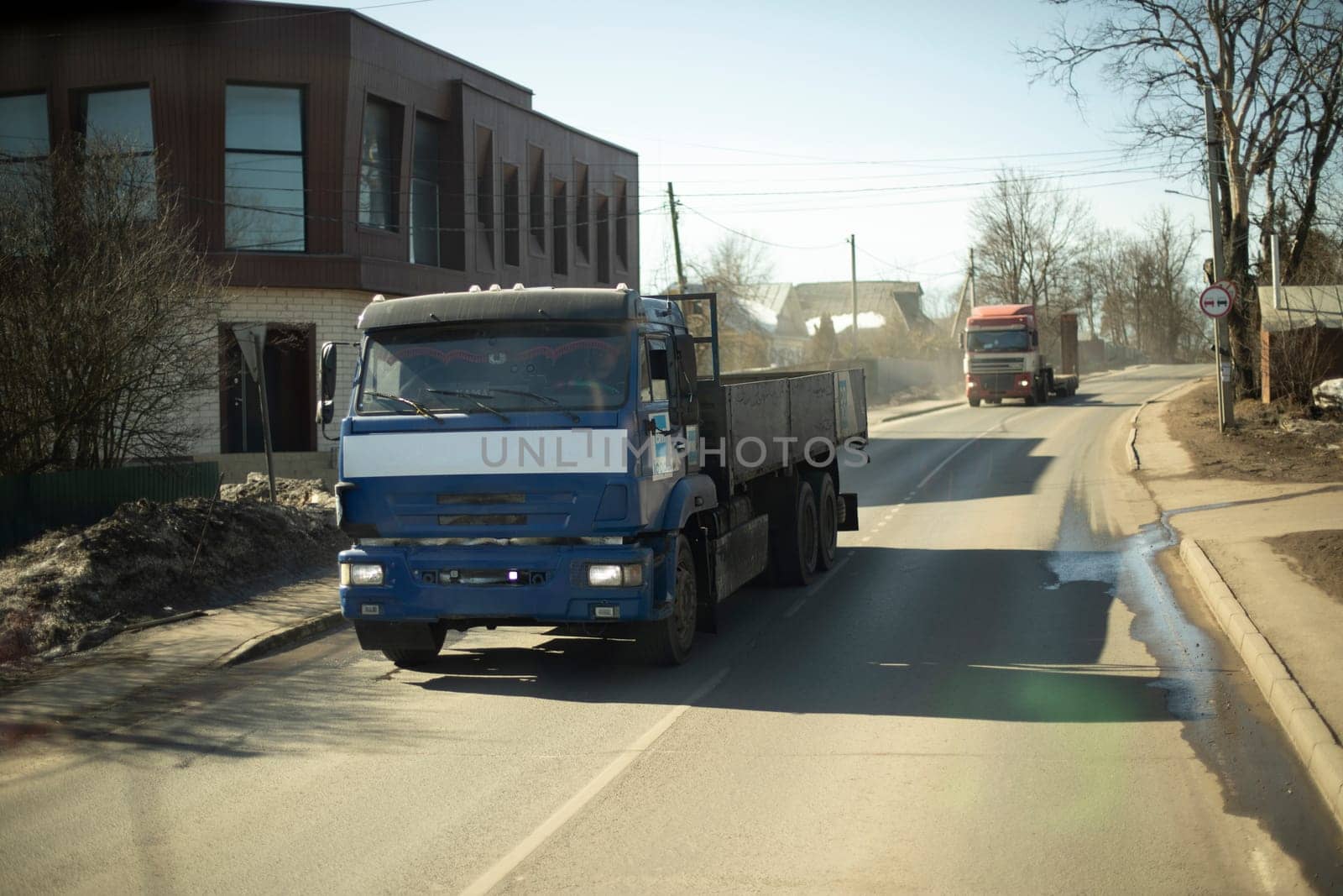 Cargo transport on road in Russia. Trans-batching of goods. Car with trailer.