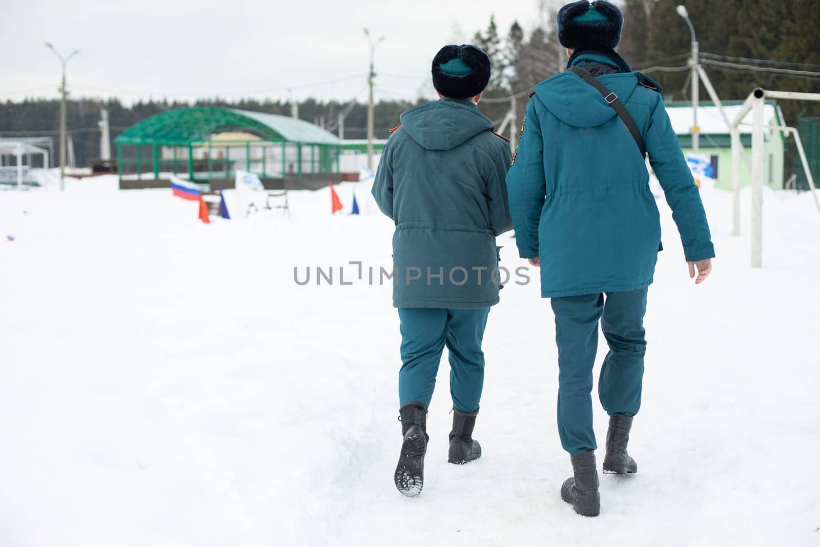 Two guys in uniform. Men come from service in Russia. People in warm clothes in Siberia. Blue shape. Rescue service.