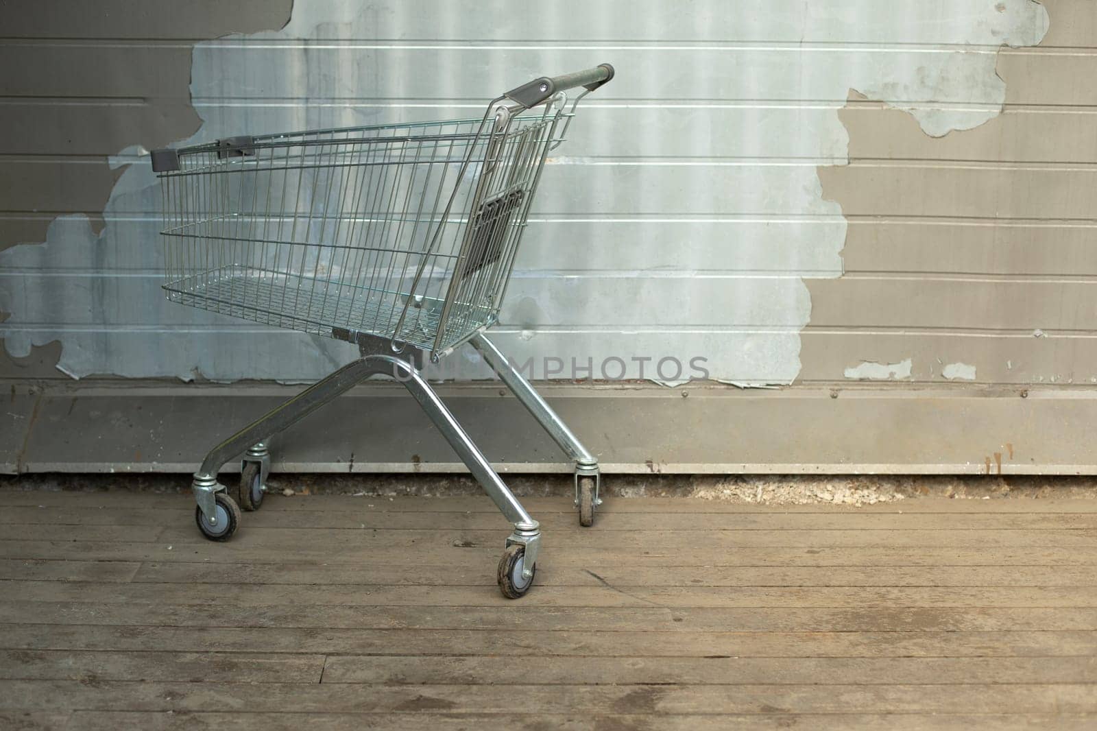 Cart for groceries from supermarket. Steel basket for goods on street. by OlegKopyov