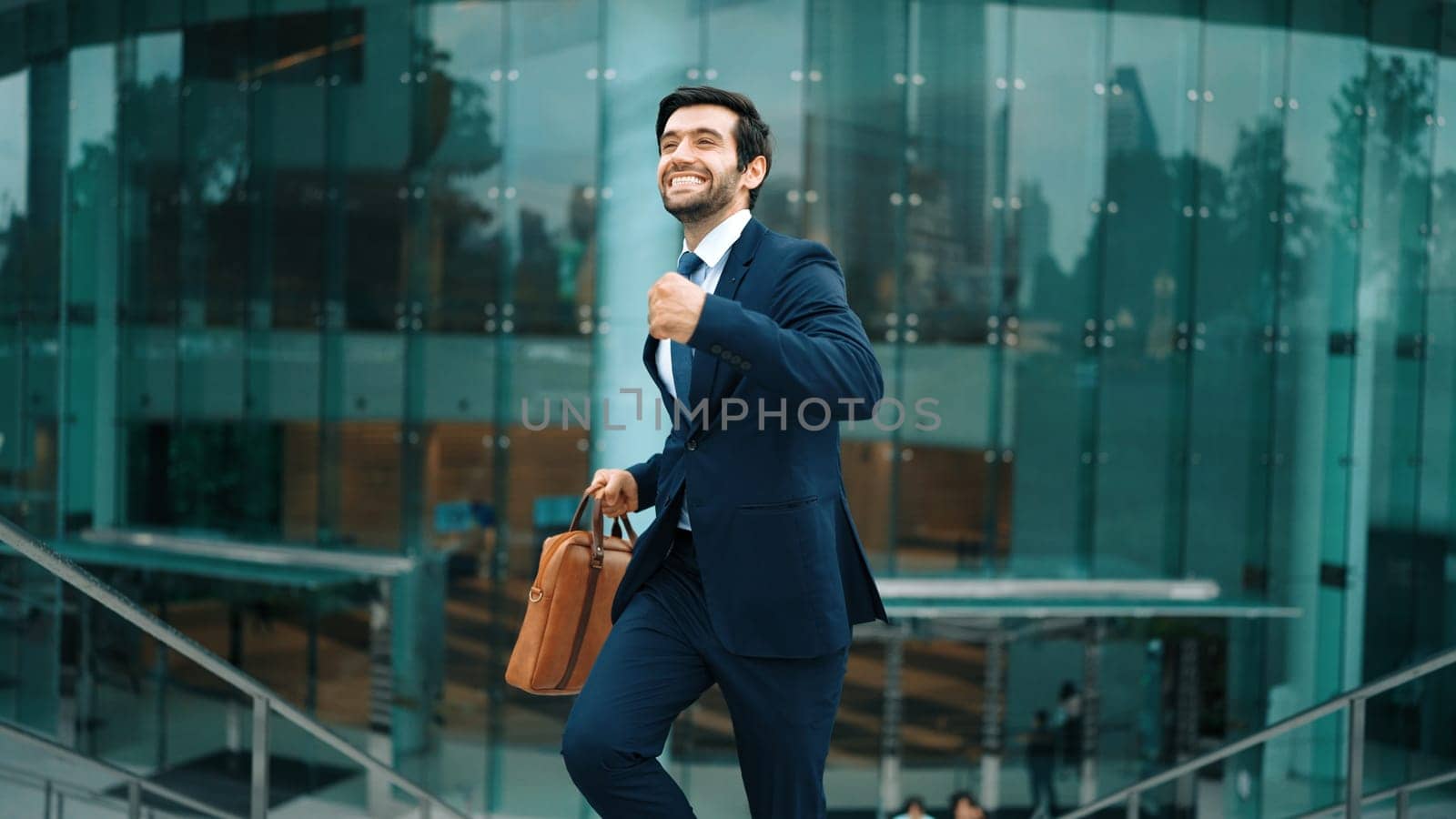 Successful businessman celebrate for getting promotion while walking. Exultant. by biancoblue
